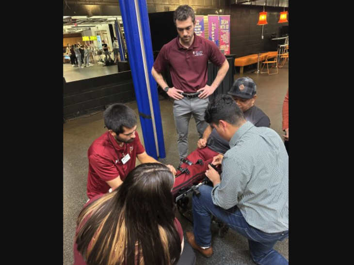 DPT students and Engineering student apply customized knee braces for client with a spinal cord injury.